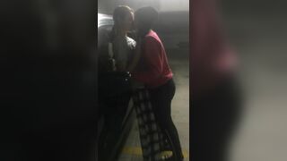 Friends having fun on the parking lot - Girls Kissing