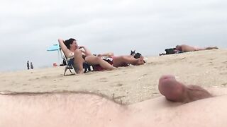 guy pretends to be asleep on the beach whilst people watch him cum two