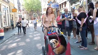 Humorous: Just a nude gal shoving a bulldog in a stroller in Chinatown