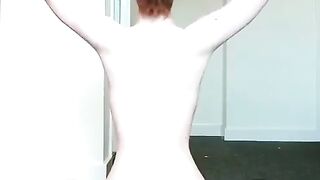 Letting her long, copper-red hair fall onto her bare back; then making waves. - Oddly Satisfying
